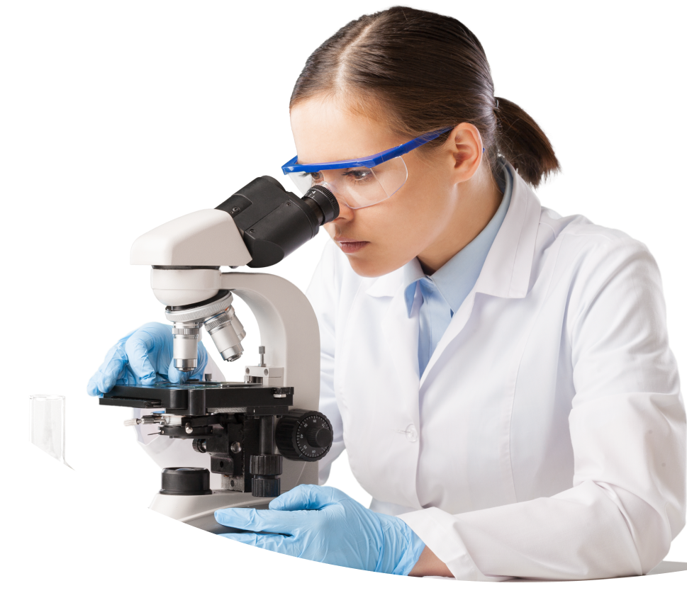 Lady wearing safety goggles and looking at a slide through a microscope